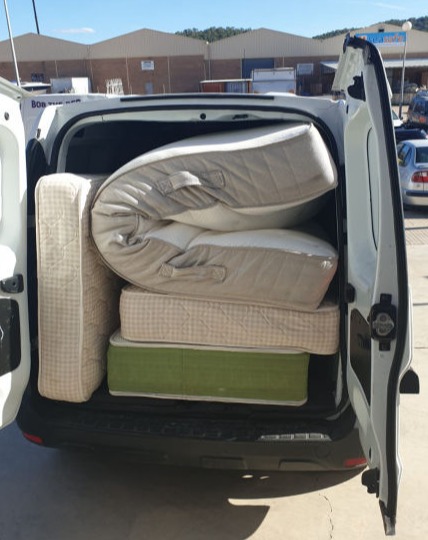 A van filled to the brim with mattresses