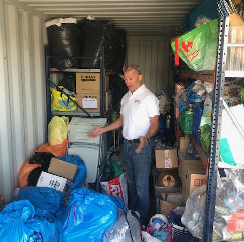 A man in container surrounded by donated materials