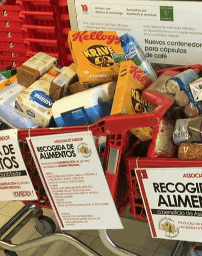 A supermarket trolley filled with donated food items