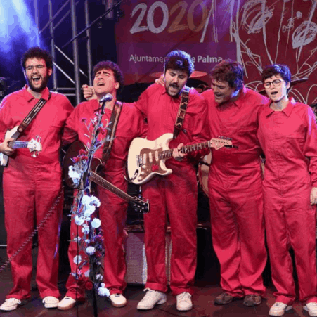 A group dressed in red overall sing an play instruments