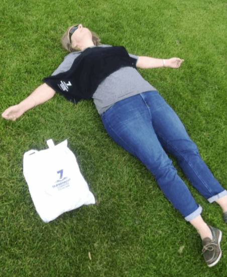 An exhausted woman lying on the grass